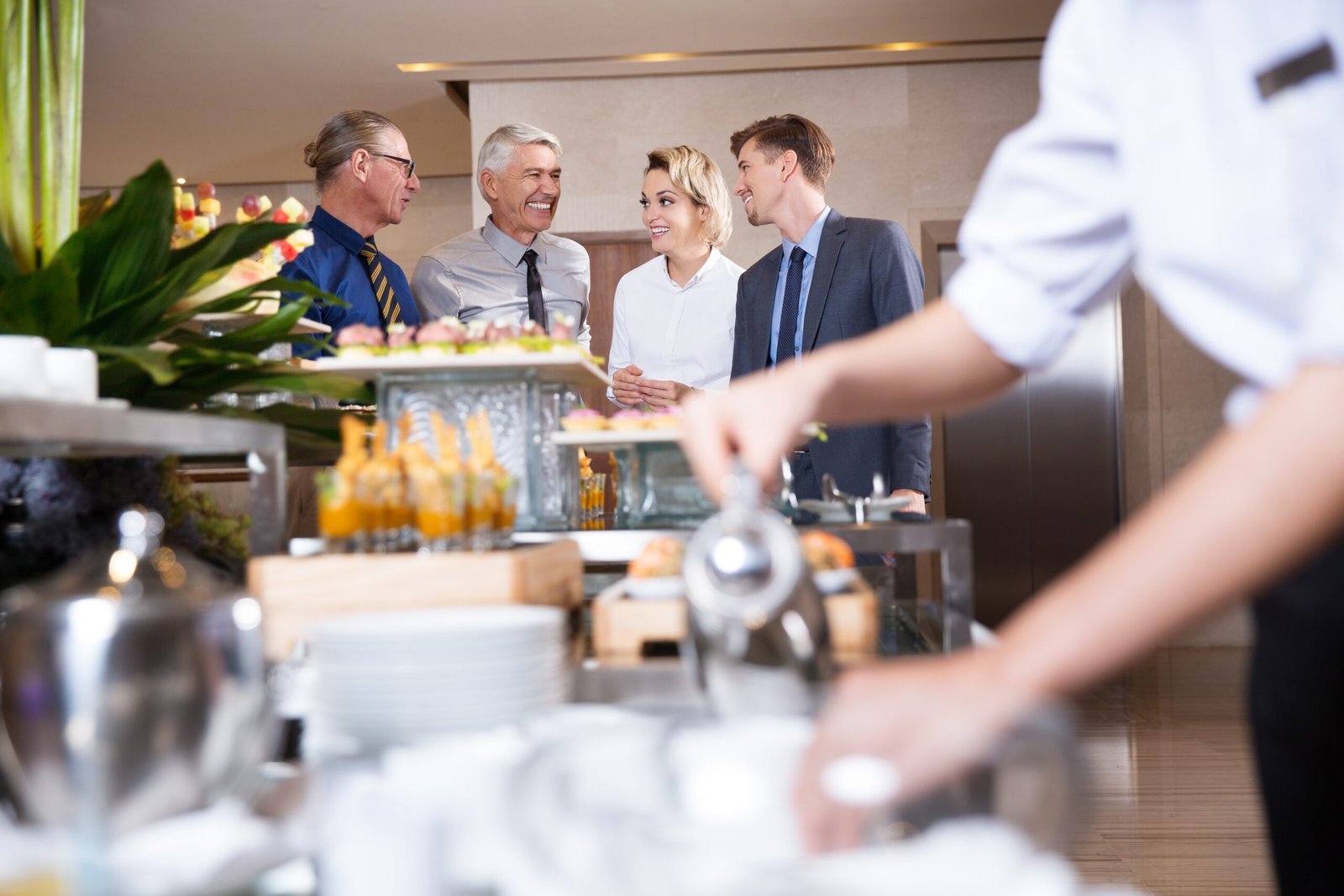 four smiling business people buffet table.jpg 1 1 scaled.jpeg